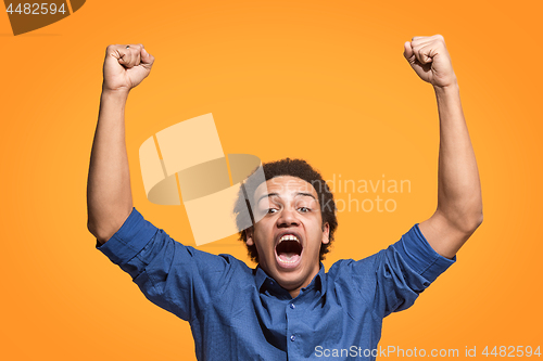 Image of Winning success man happy ecstatic celebrating being a winner. Dynamic energetic image of male model