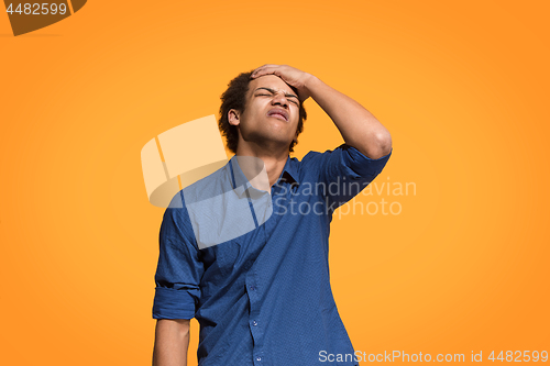 Image of Beautiful bored man bored isolated on orange background