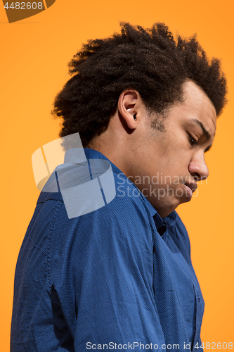 Image of Beautiful bored afro man isolated on orange background