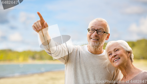 Image of happy senior couple over beach background