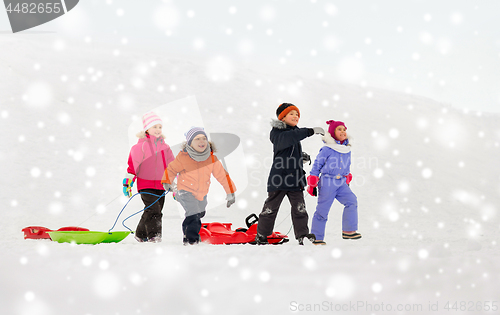 Image of happy little kids with sleds in winter