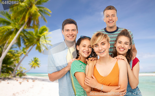 Image of happy friends over tropical beach background