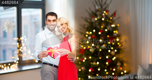 Image of happy couple with heart shaped christmas gift box