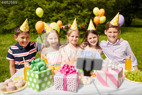 Image of happy kids taking selfie on birthday party