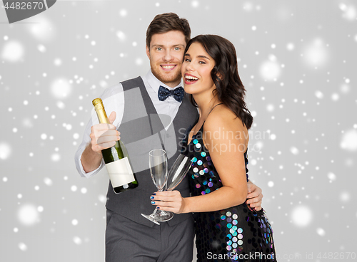 Image of happy couple with champagne celebrating christmas