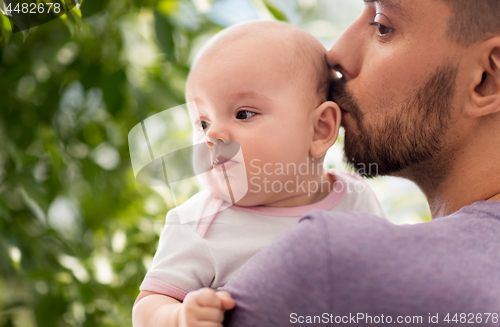 Image of close up of father kissing little baby daughter