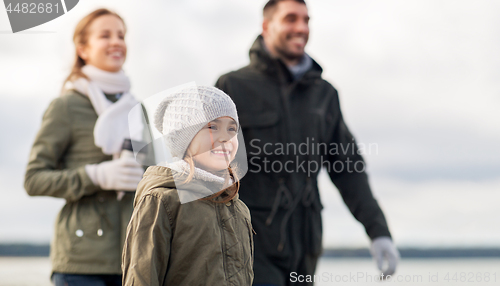 Image of happy girl with family at autumn beach