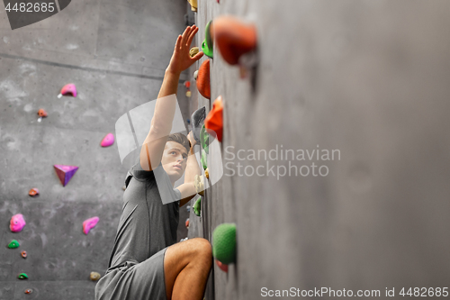 Image of young man exercising at indoor climbing gym