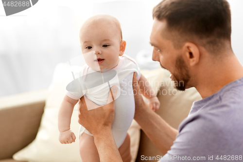 Image of father with little baby girl at home