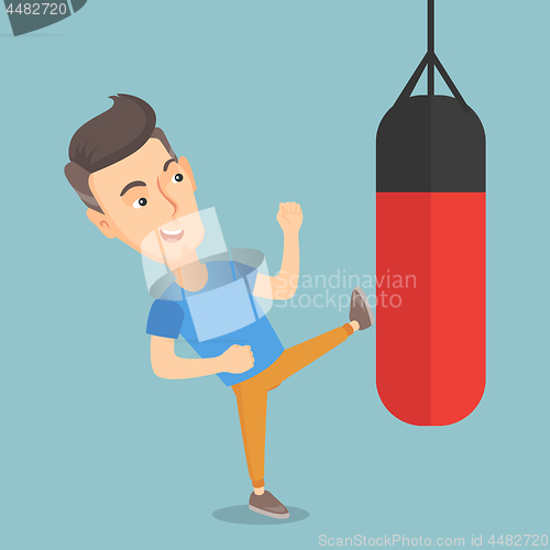 Image of Man exercising with a punching bag.