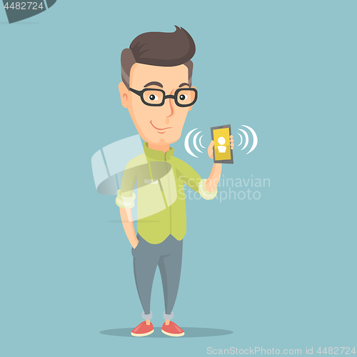 Image of Man holding ringing mobile phone.