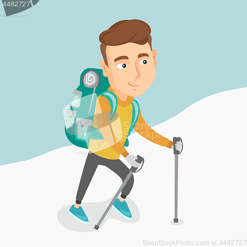 Image of Young mountaneer climbing a snowy ridge.