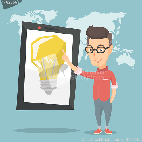 Image of Man pointing at big tablet computer.