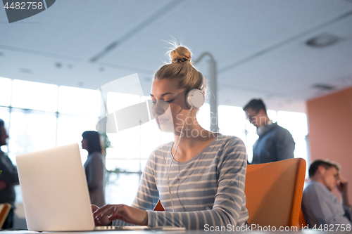 Image of businesswoman using a laptop in startup office