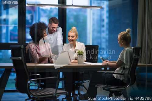 Image of Multiethnic startup business team in night office