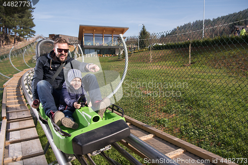 Image of father and son enjoys driving on alpine coaster