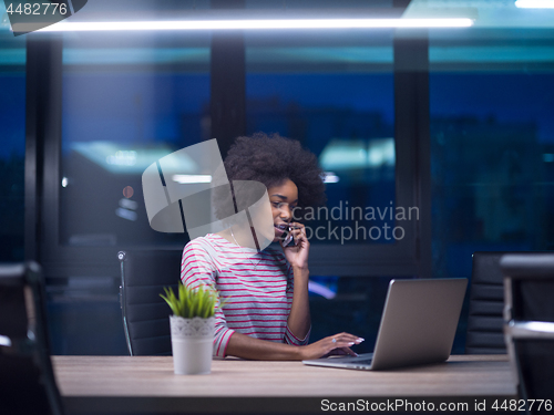 Image of black businesswoman using a laptop in startup office