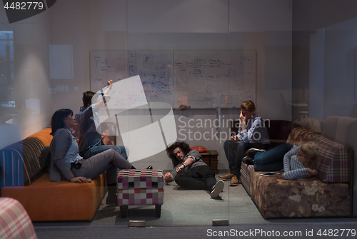 Image of software developers sleeping on sofa in creative startup office