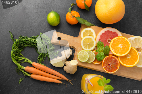 Image of fruits, vegetables, cutting board and juice