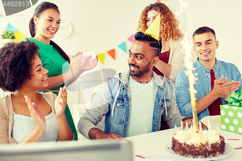 Image of office team greeting colleague at birthday party