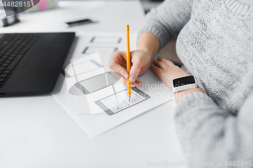 Image of web designer working on user interface at office