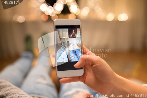 Image of close up of couple taking foot photo by smartphone