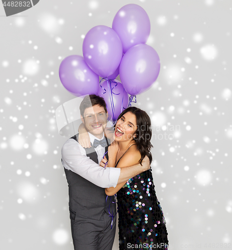 Image of happy couple with ultra violet balloons at party