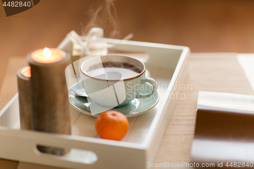 Image of hot chocolate, christmas gift and candles on table