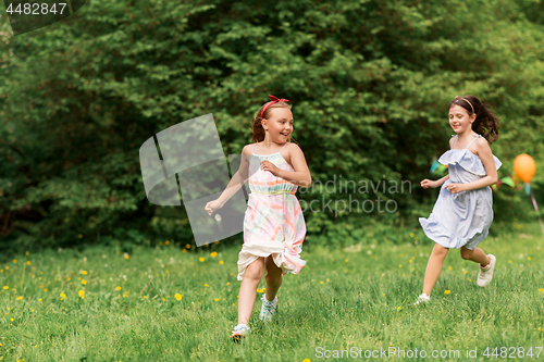 Image of happy girls playing tag game at birthday party