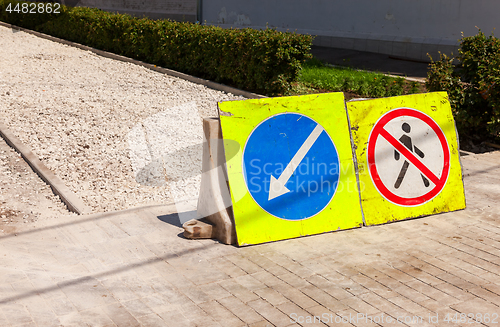 Image of Road signs at the under construction sidewalk in summer day