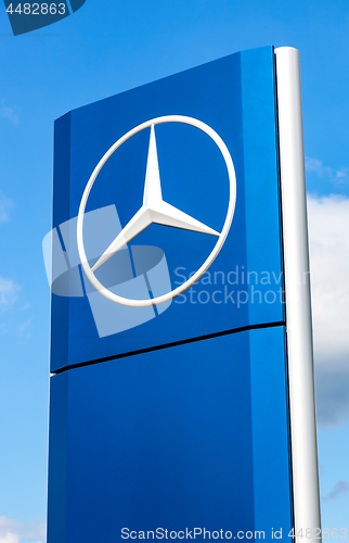 Image of Official dealership sign of Mercedes-Benz over blue sky