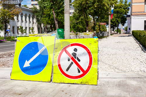 Image of Road signs at the under construction sidewalk in summer day