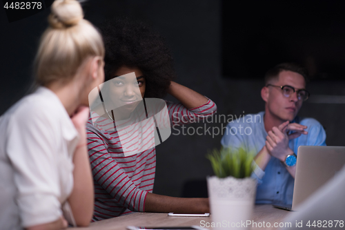 Image of Multiethnic startup business team in night office