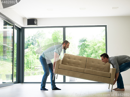 Image of men carry the sofa