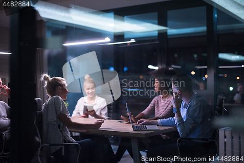 Image of Multiethnic startup business team in night office