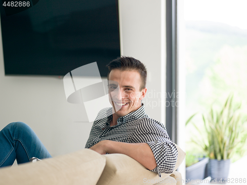 Image of man on sofa using tablet computer
