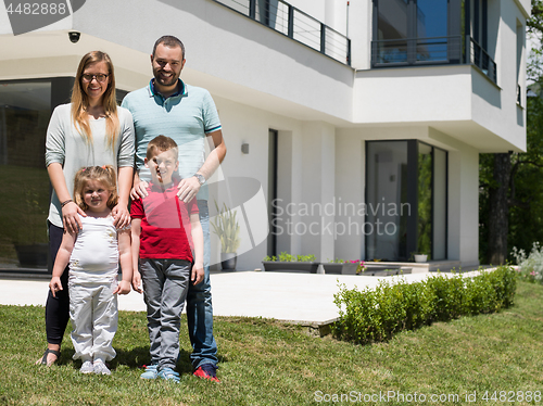 Image of happy family with children in the yard