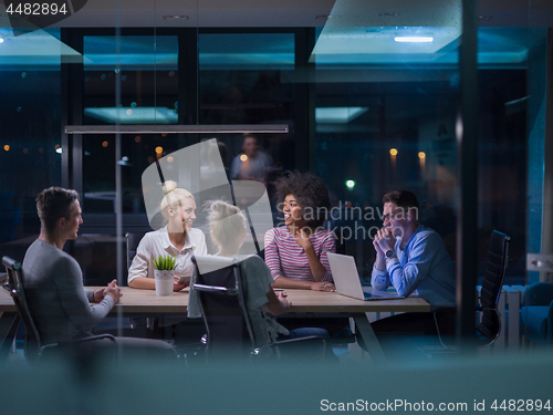 Image of Multiethnic startup business team in night office