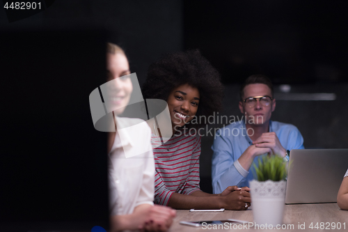 Image of Multiethnic startup business team in night office