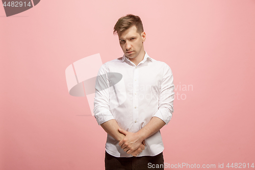 Image of Let me think. Doubtful pensive man with thoughtful expression making choice against pink background