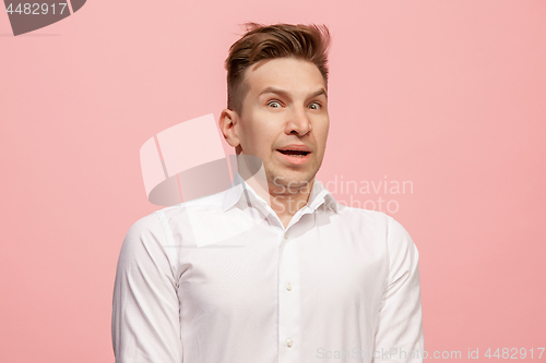 Image of Handsome man looking suprised isolated on pink