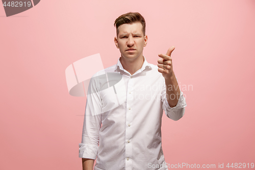 Image of The overbearing businessman point you and want you, half length closeup portrait on pink background.