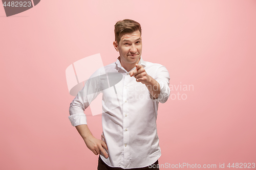 Image of The happy business man point you and want you, half length closeup portrait on pink background.