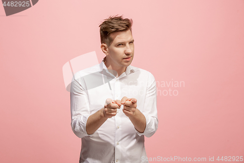 Image of The happy business man point you and want you, half length closeup portrait on pink background.