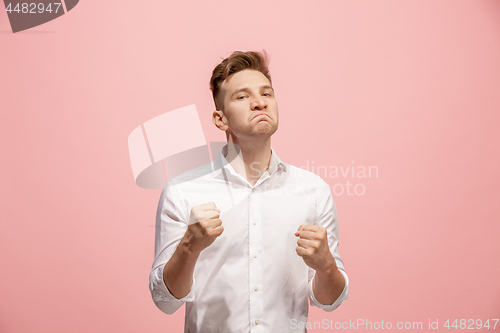 Image of The young emotional angry man screaming on pink studio background