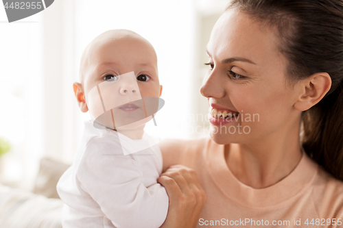 Image of happy mother with little baby boy at home