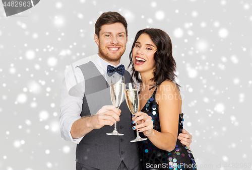 Image of happy couple with champagne celebrating christmas