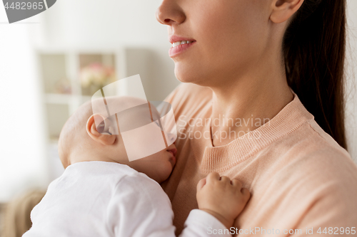 Image of close up of mother holding sleeping baby