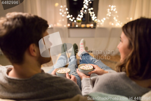 Image of close up of couple drinking hot chocolate at home