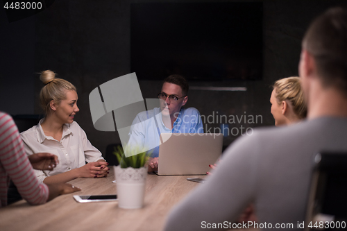 Image of Multiethnic startup business team in night office